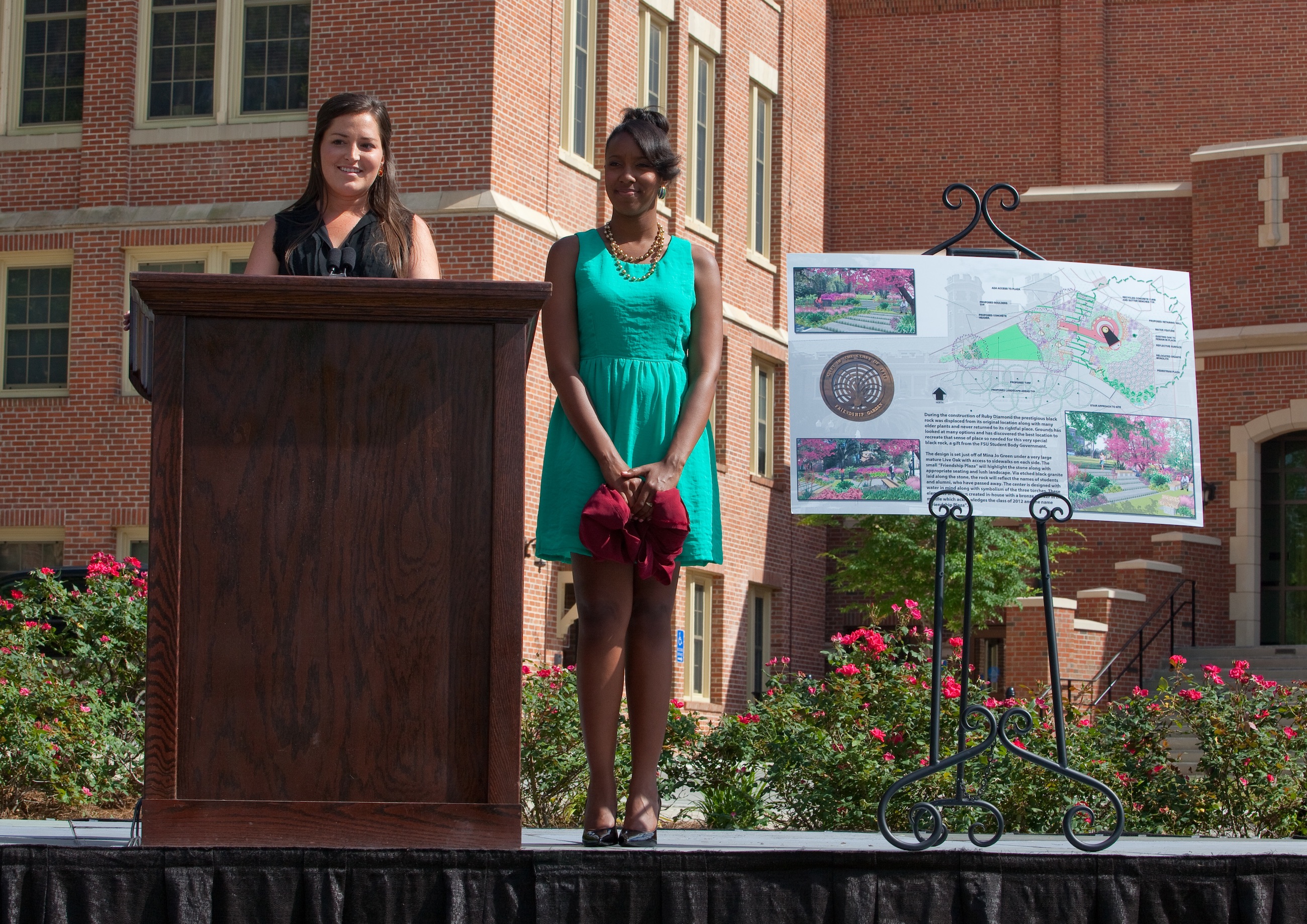 2012 Senior Class Council President Kimberly Siddle, left, and Treasurer Jasmine Styles reveal plans for a new garden to be located within Mina Jo Powell Green.