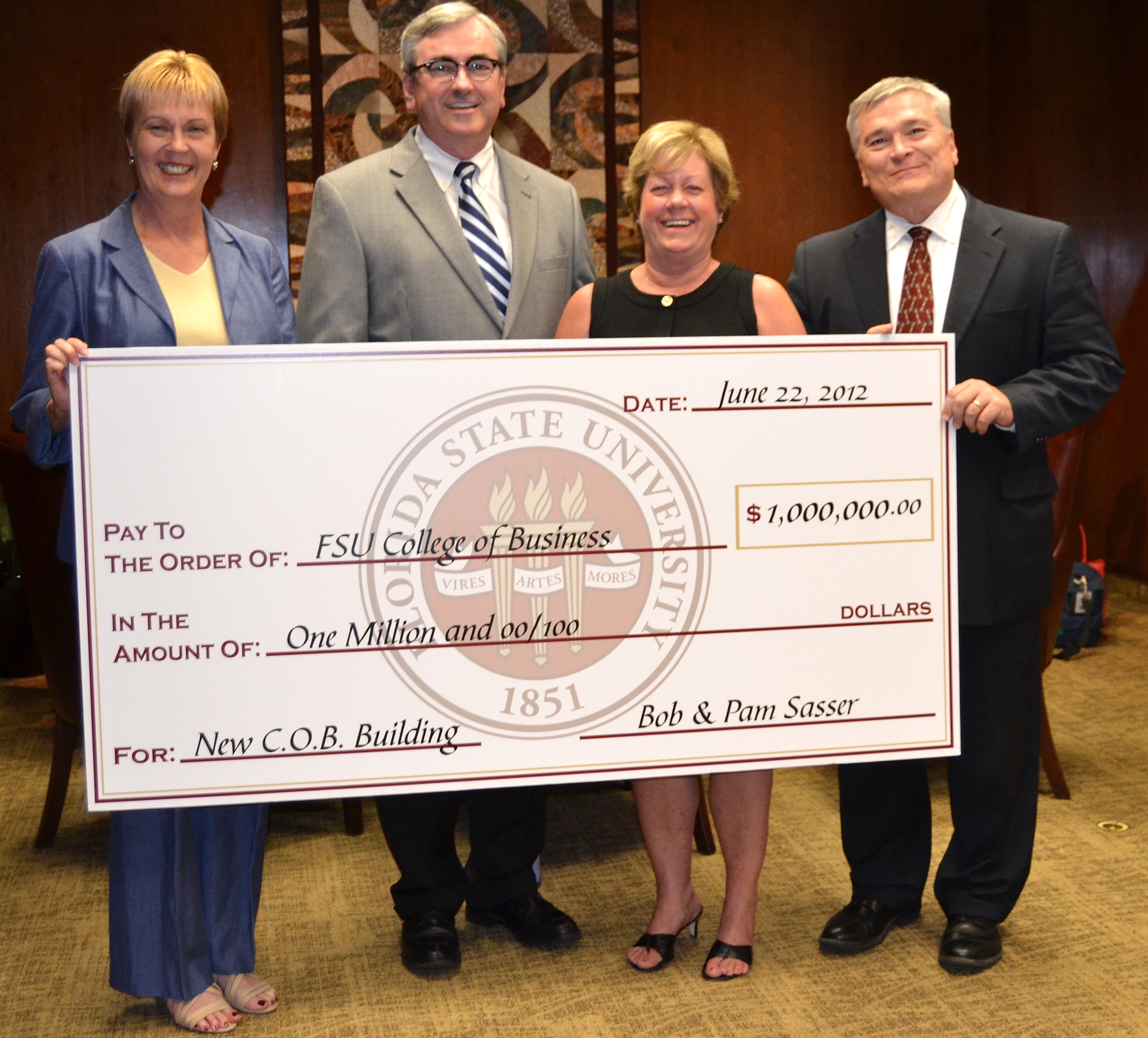 Holding the $1 million check are, from left, College of Business Dean Caryn Beck-Dudley; Bob Sasser; Pam Sasser; and Florida State President Eric J. Barron.