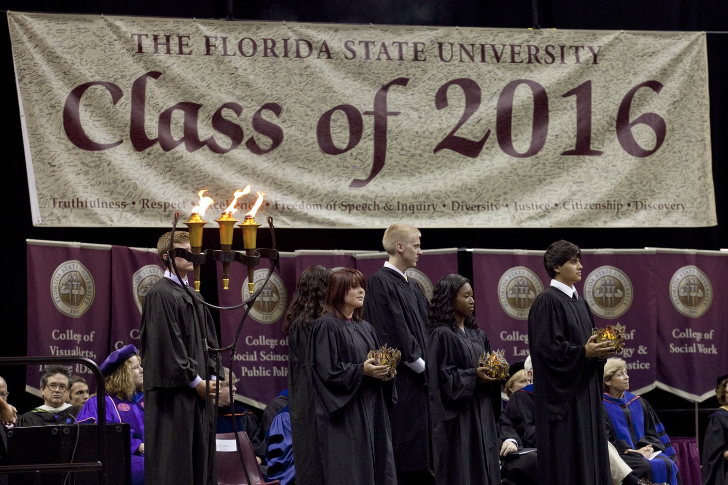 During the Torch Ceremony, three upperclassmen passed torches to three freshmen, symbolically passing the university’s ideals from one class to the next. The torches stand for Vires (strength), Artes (skill) and Mores (character) as depicted in the Florida State University seal.