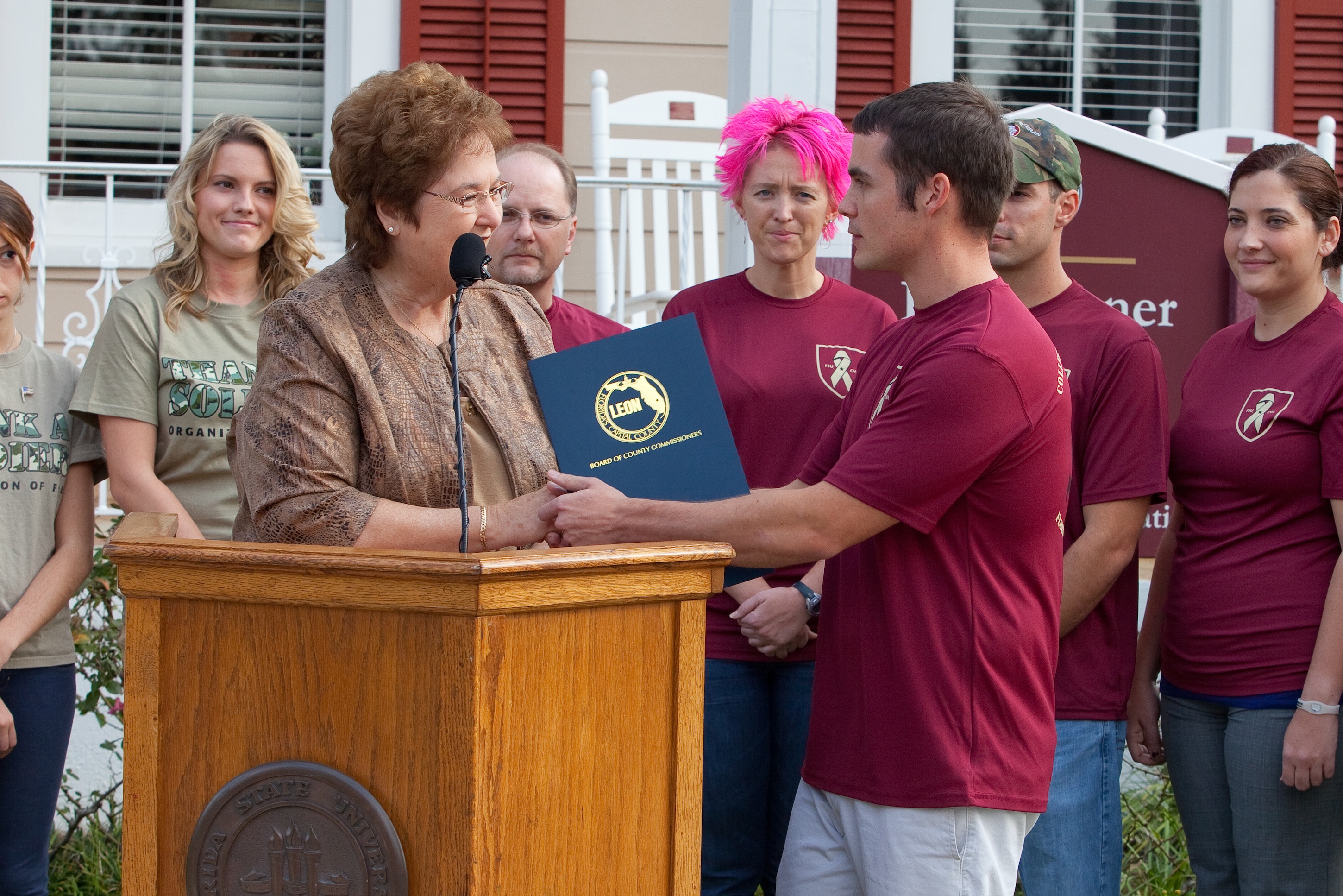 Collegiate Veterans Association Ryan Taylor accepts the resolution from Leon County Commissioner Jane Sauls as members of the CVA and the Thank a Soldier Organization of FSU look on.