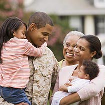 African American military father hugging family