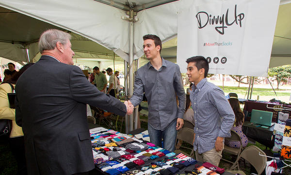 President John Thrasher with student entrepreneurs at event on Landis green