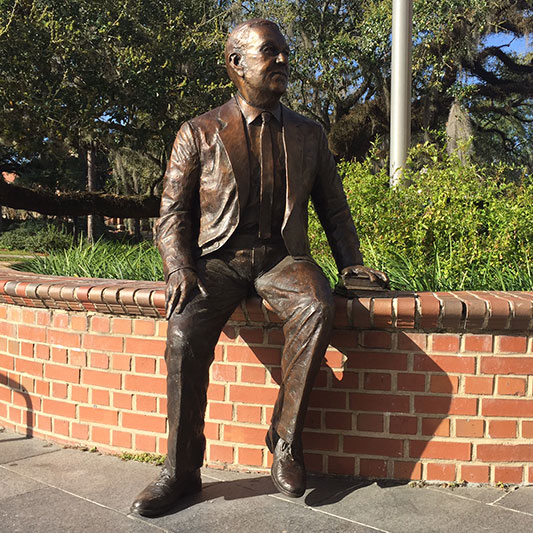 a statue of former FSU President Robert Manning Strozier on the steps of Strozier Library