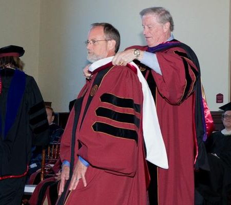 President Thrasher hoods Christopher Still with an Honorary Doctor of Humane Letters from Florida State University.