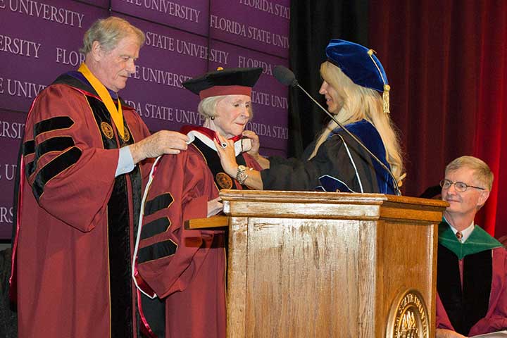 President John Thrasher hoods Grace Dansby as she receives an honorary doctorate Tuesday, Aug. 9.