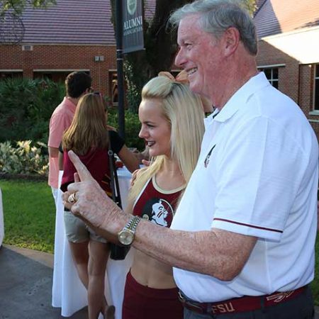 President John Thrasher poses for photos with students at the FSU Traditions BBQ.