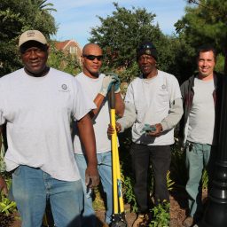 Planting crew poses for a photo after working outside the Westcott building.