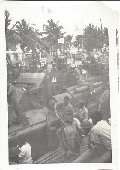 This image depicts PT-41 which was the flagship of Motor Torpedo Squadron 3. You notice clearly marked number 41 on the side of the bridge, as well as the squadron number 3 flag raised above the bridge. This image was most certainly taken on December 10 or shortly thereafter. You can see the soldiers wearing helmets/rifles and hastily loading PT-41. It even looks like the man in the right lower foreground has a camera! This exact boat carried General Douglas MacArthur and his family to safety from Corregidor to Mindanao on March 12, 1942, thus enabling MacArthur to escape and to make his famous