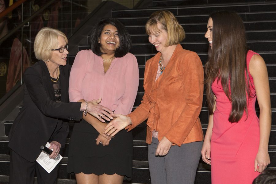 3 Minute Thesis Finalist Competition Dr. Judy Devine congratulates, from left, Madhuparna Roy (winner), Shaleen Miller (runner-up) and Tania Reynolds (People's Choice).
