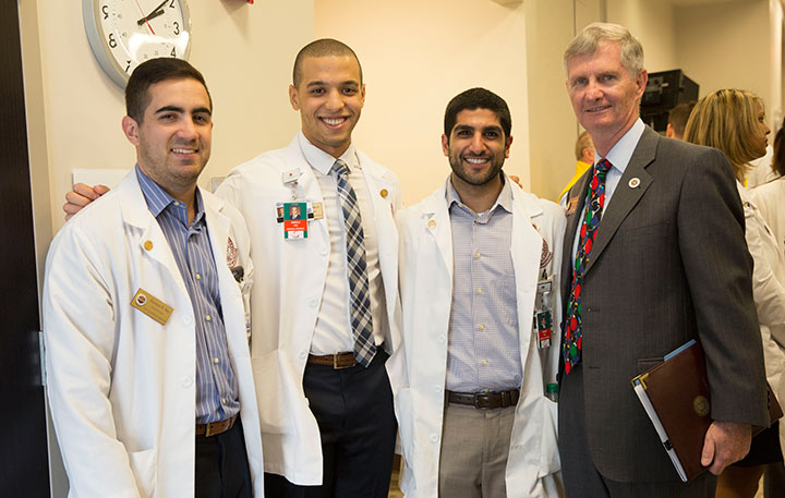 Third-year FSU medical students Gustavo Rey, Arnold Abud, Shawn Hassani with College of Medicine Dean John Fogarty at Orlando Health Friday, Dec. 9.