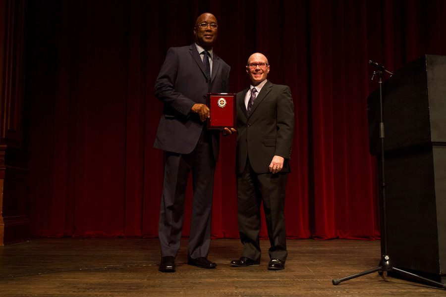 Darryl Marshall, assistant vice president of financial aid, receives the 2017 Dr. Martin Luther King Jr. Award from past recipient Bruce Lamont at the 29th Annual MLK Celebration Tuesday, Jan. 17. Photo credit: Lauren Alsina