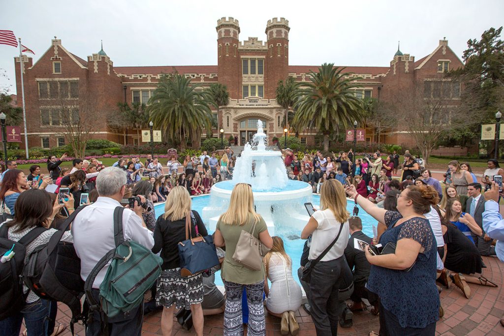 Graduates, parents and friends gather for the tradition of ring dipping at the Westcott Fountain at the 2017 FSU Ring Ceremony Thursday, March 30.