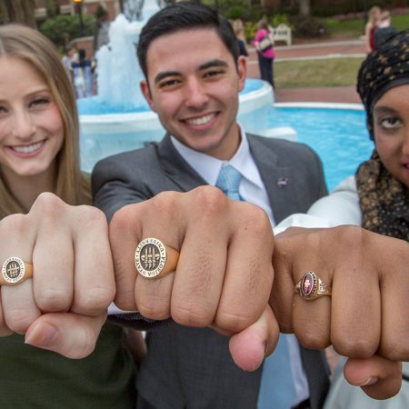 Soon-to-be FSU graduates Valerie Shallow, Nathan Molina and Inam Sakinah show off their new class rings during the 2017 FSU Ring Ceremony Thursday, March 30.
