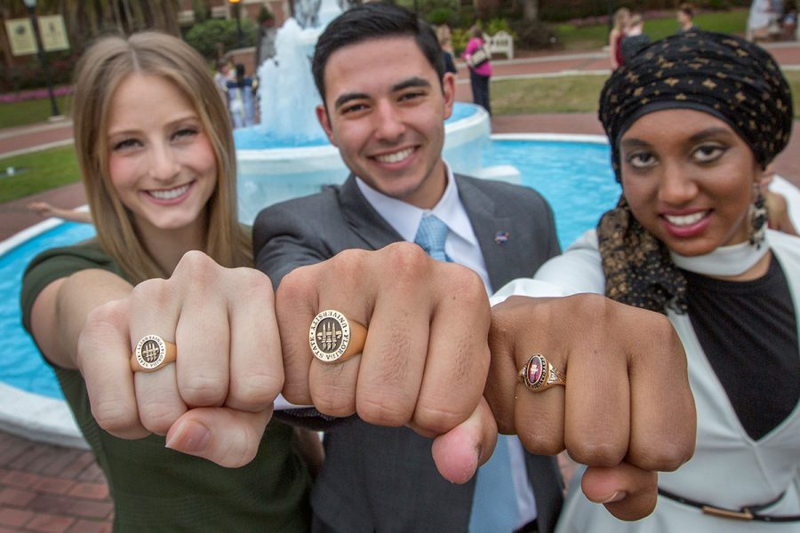 Soon-to-be FSU graduates Valerie Shallow, Nathan Molina and Inam Sakinah show off their new class rings during the 2017 FSU Ring Ceremony Thursday, March 30.