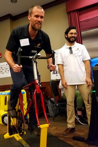 FSU doctoral student Erik Inglis tests out an ergometer on a stationary bike at DIGITECH 2017.