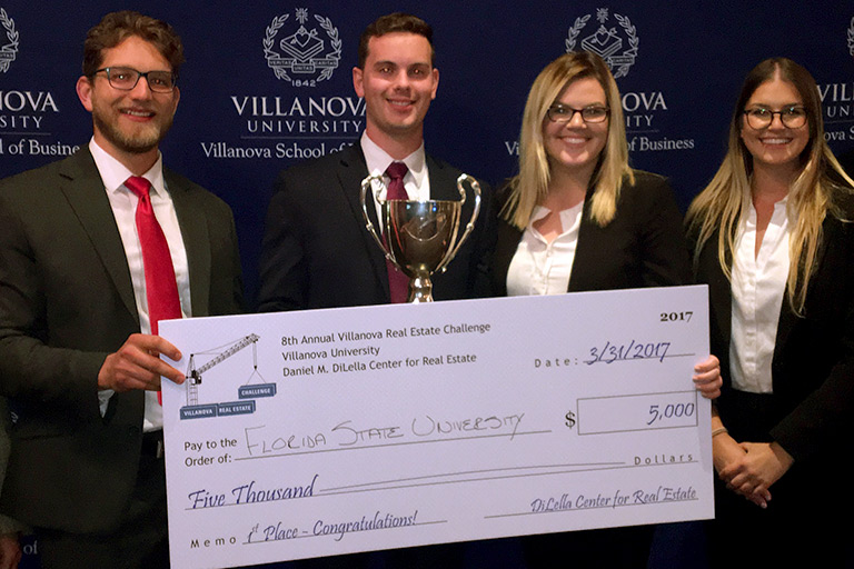 Race Smith, Michael Walsh, Sarah Flemister and Michelle Langborgh accept the winning check for $5,000.