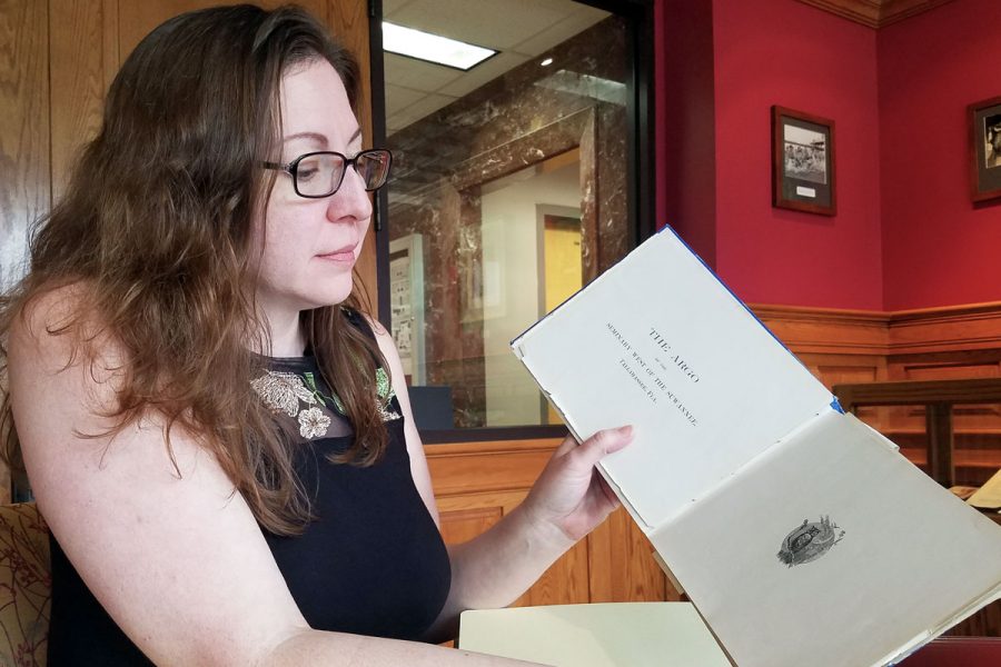 University Archivist Sandra Varry looks through a 1901 copy of the yearbook,'The Argo.'