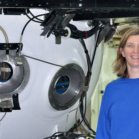 Associate Professor of Earth, Ocean and Atmospheric Science Amy Baco-Taylor next to a submersible in which she has conducted research.