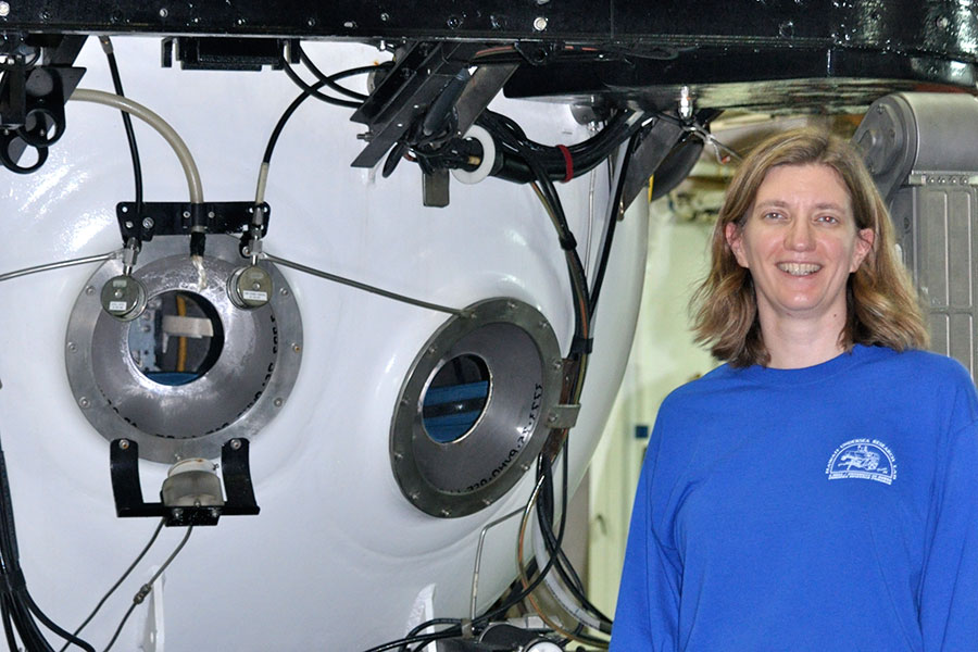 Associate Professor of Earth, Ocean and Atmospheric Science Amy Baco-Taylor next to a submersible in which she has conducted research.