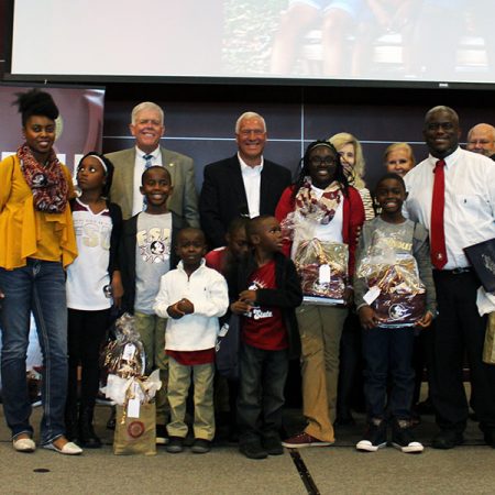 FSU Panama City Dean Randy Hanna, Chipola College President Sarah Clemmons and Gulf Coast State College President John Holdnak awarded each child of the Olds family with guaranteed scholarships Aug. 17 at FSU Panama City’s Welcome Back Symposium.