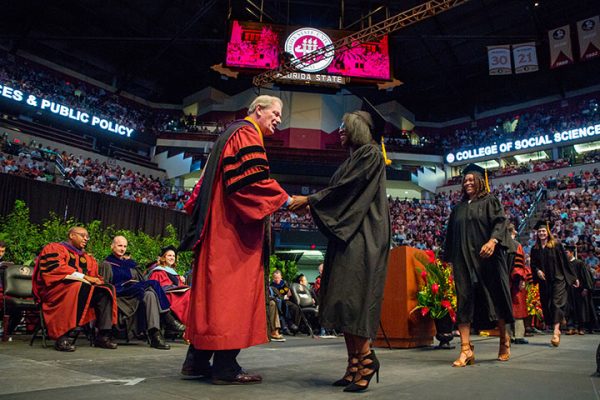 Summer commencement graduates were all smiles greeting President Thrasher as their names were announced.