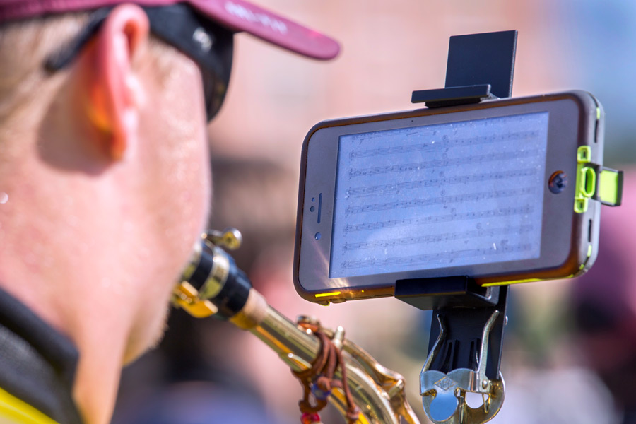 The Marching Chiefs are using the “eFlip” attachment, which allows them to follow their song music on a smartphone instead of printed sheets.