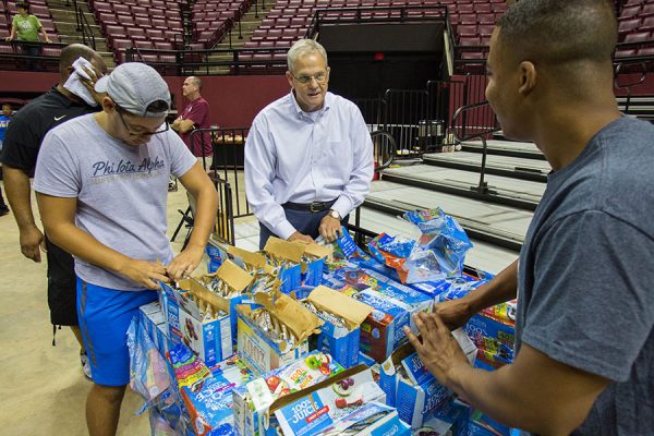 SUS Chancellor Marshall Criser III helps make care packages with FSU students. (FSU Photography Services)