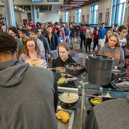 Student-athletes helped serve game day fare of hamburgers and hot dogs to more than 6,000 students at the Dunlap Champions Club Monday evening.