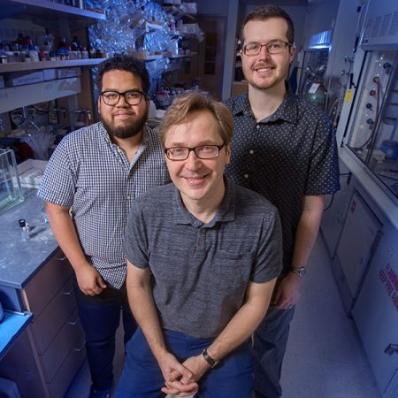 Professor Igor Alabugin with graduate students Gabriel dos Passos Gomes and Trevor Harris have developed a way to make a critical chemical reaction more effective and safe for work in biological systems. (FSU Photography Services)
