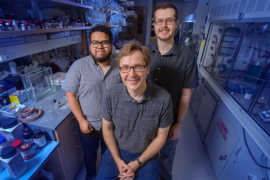 Professor Igor Alabugin with graduate students Gabriel dos Passos Gomes and Trevor Harris have developed a way to make a critical chemical reaction more effective and safe for work in biological systems. (FSU Photography Services)