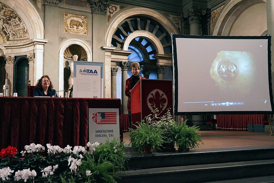 Nancy de Grummond accepts the award of merit from the Tuscan American Association in the Salone dei Cinquecento (Room of the 500) at the town hall of Florence, the Palazzo Vecchio. Andrea Davis, president of the association, looks on.