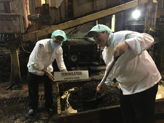 Executive chefs Travis Johnson and Thomas Gilbert churning soil.