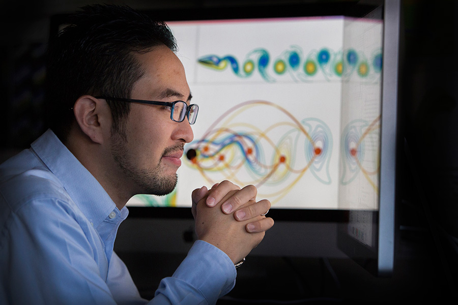 Assistant Professor of Mechanical Engineering Kunihiko (Sam) Taira reviews data in his lab.