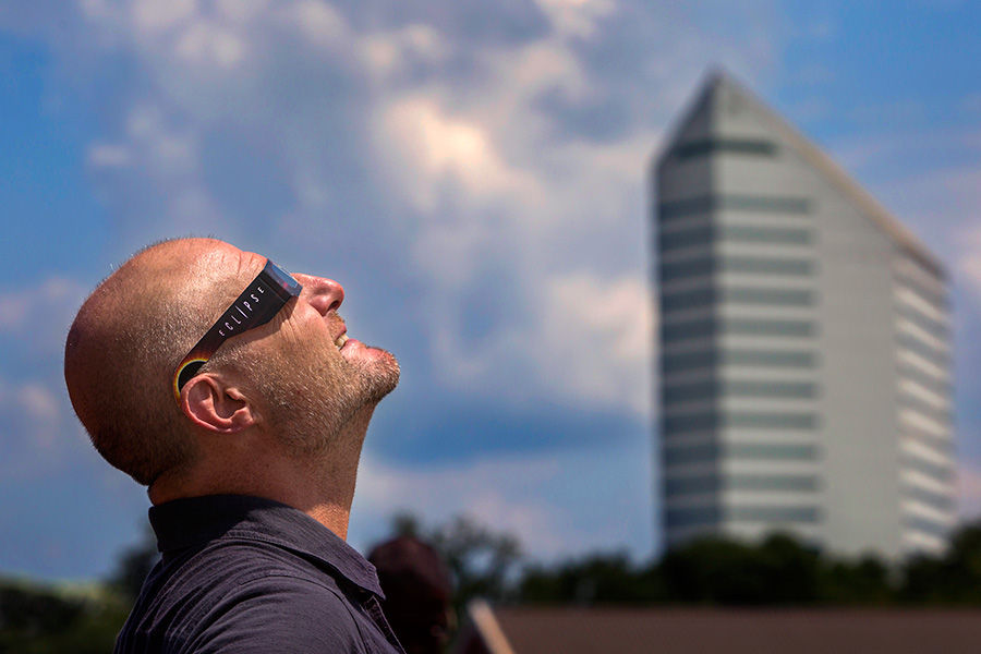 During the 2017 solar eclipse, Jim Moran School of Entrepreneurship's Entrepreneur in Residence Mark McNees views the event from atop the Turnbull Center parking deck.