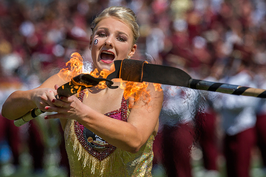 Marching Chiefs majorette Cassie Roby twirls flaming knives during halftime of the FSU-NC State football game.
