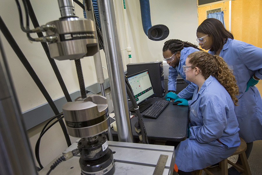 Graduate students Meagan Raley (seated), Marquese Pollard and Tolulope Sosan work at the High-Performance Materials Institute through their program at the FAMU-FSU College of Engineering.