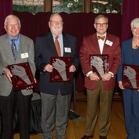 Four members of the FSU family were honored with Torch Awards on Monday, Dec. 4. From left: Kirby Kemper (Vires), Guy Spearman (Mores), Ash Williams (Mores) and Jan Moran (Vires). (Photo: Photography Services)