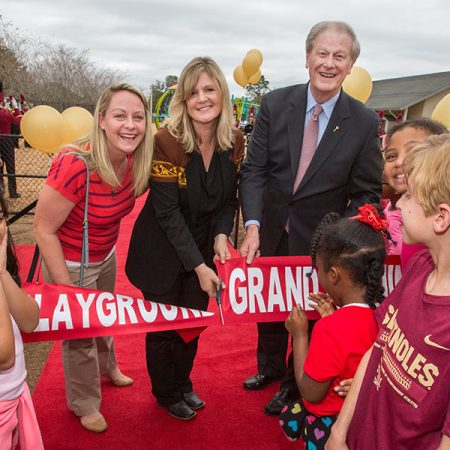 FSUS Executive Director Stacy Chambers and President John Thrasher with parents and students at the new playground's ribbon-cutting Feb. 14. (FSU Photography Services)