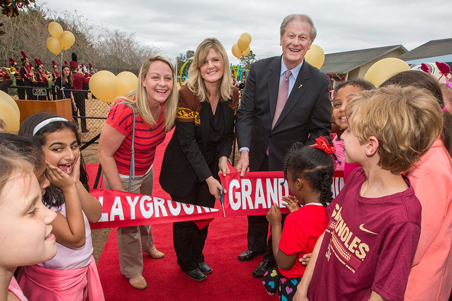 FSUS Executive Director Stacy Chambers and President John Thrasher with parents and students at the new playground's ribbon-cutting Feb. 14. (FSU Photography Services)