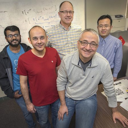 (From left) Graduate students Arun Polala and Navid Salehy, Professor and Director of Financial Mathematics Alec Kercheval, Professor Giray Okten and Assistant Professor Lingjiong Zhu are a part of one of the most well-respected financial mathematics programs in the nation. (FSU Photography Services)