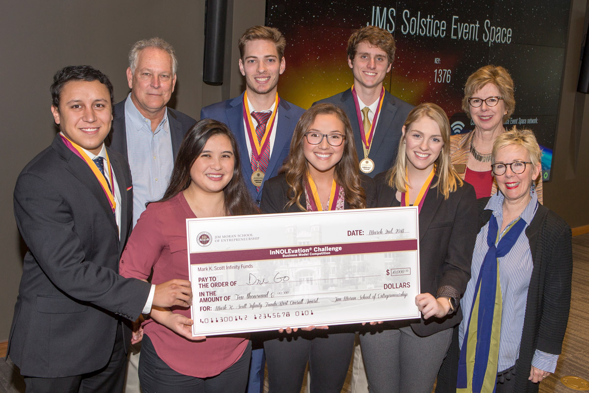 Members of the DriGo team: Jose Miranda (far left), Brianna Yeung (left center), Megan Simpson (center), Claire Kelly (right center), Susan Fiorito, Director, Jim Moran School of Entrepreneurship (far right) BACK ROW: Mark Scott (far left), Hunter Wheeler (left center), Billy Courson (right center), Wendy Plant, Jim Moran School of Entrepreneurship (far right)