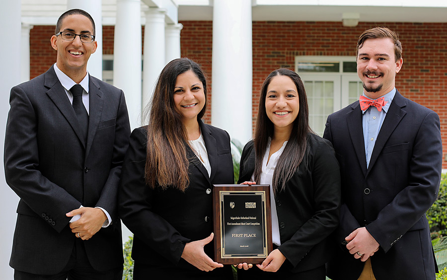 Third-year law students Jenna VonSee and Brenda Czekanski won a national moot court competition March 23-24. They were coached by College of Law alumni Jonathan Martin (left) and Ian Waldick (right),