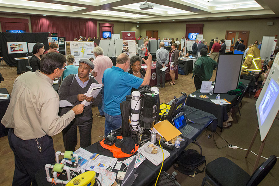 Attendees filter through the dozens of research, technology, arts and business exhibits on display throughout the Turnbull Conference Center.