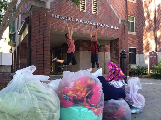 Two volunteers jump in excitement at the large number of donations collected from a residence hall. (Photo: FSU Sustainable Campus) 