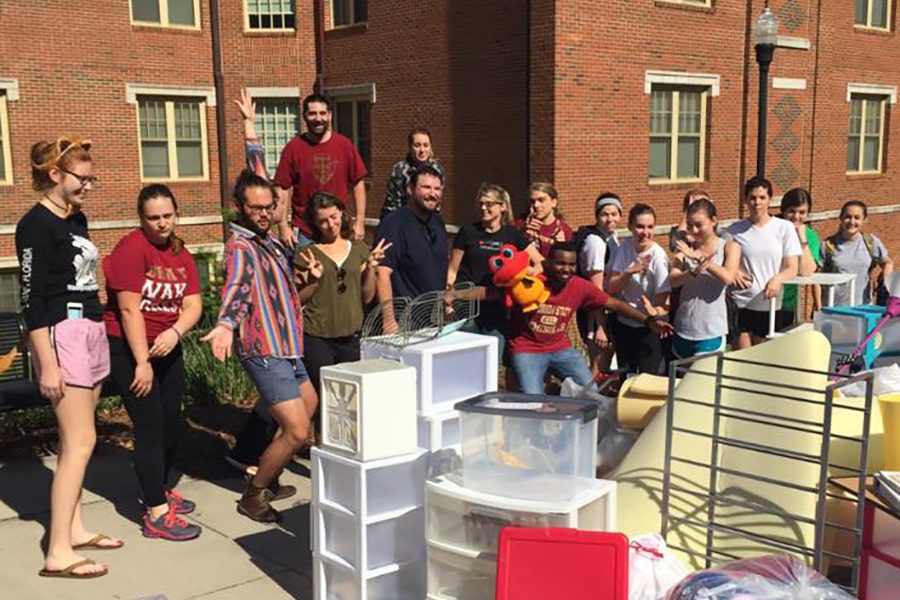 Volunteers from last year's Chuck It For Charity event stand by a collection of items from one of the residence halls. (Photo: FSU Sustainable Campus)