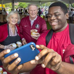 President Thrasher and his wife Jean take a selfie with an excited student during the President's Ice Cream Social. (Photo: UC Photography Services)