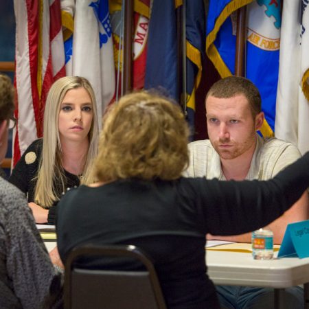 FSU law students Chandler McCoy and Joe Harrington listen to veterans and their families at the Veterans Legal Clinic held at American Legion Post #13 in Tallahassee. (FSU Photography Services)