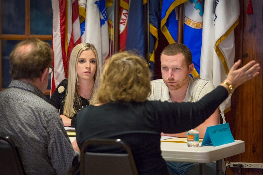 FSU law students Chandler McCoy and Joe Harrington listen to veterans and their families at the Veterans Legal Clinic held at American Legion Post #13 in Tallahassee. (FSU Photography Services)