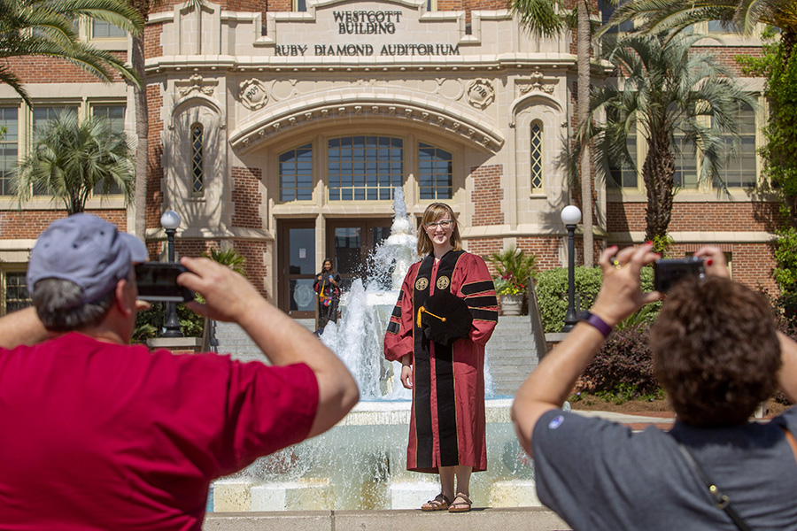 FSU Graduates pose for photos in front of Westcott before the 2018 commencement ceremonies.