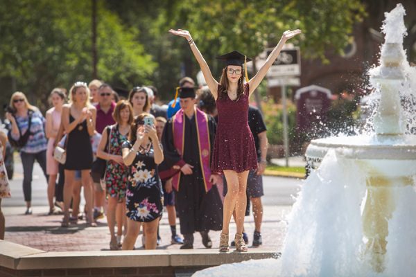 FSU Graduates pose for photos in front of Westcott before the 2018 commencement ceremonies.